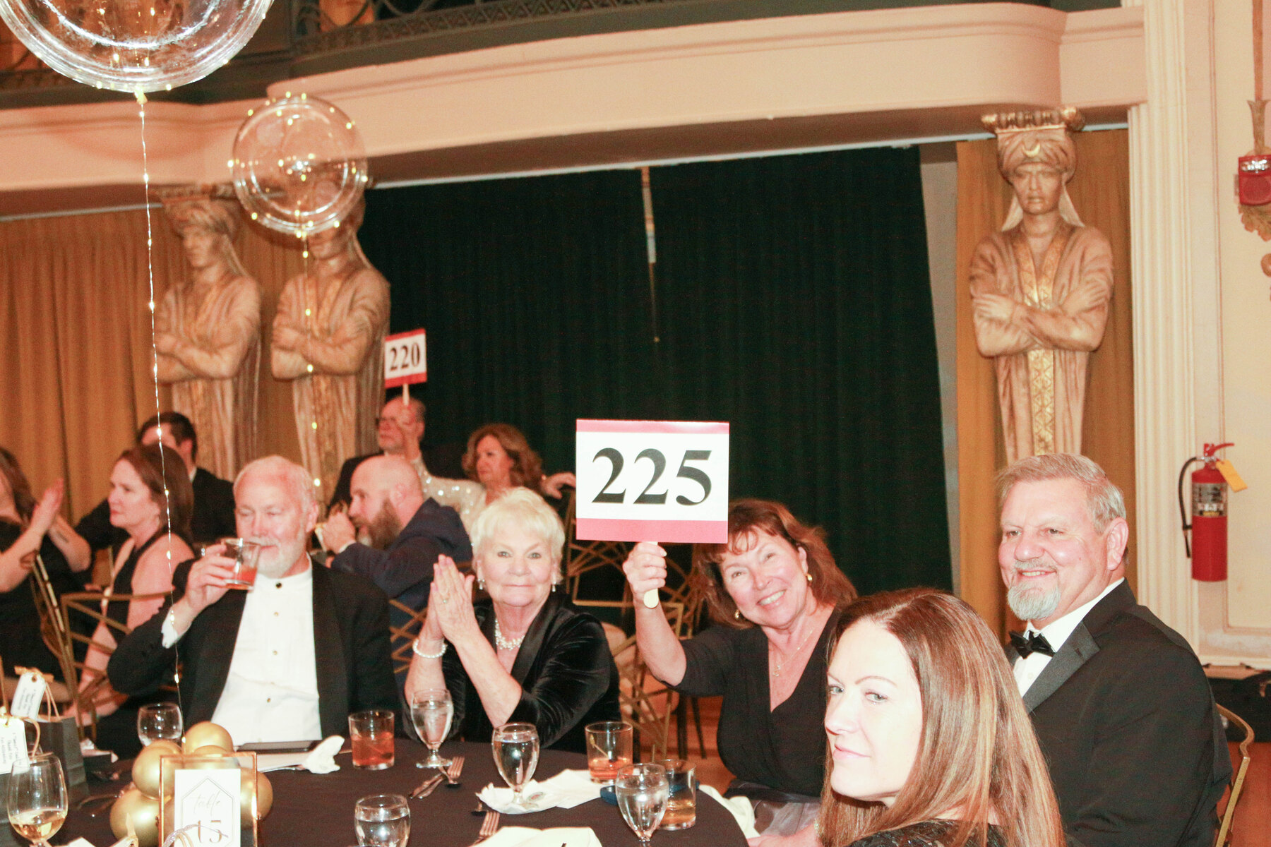 Guests celebrating a successful bid.